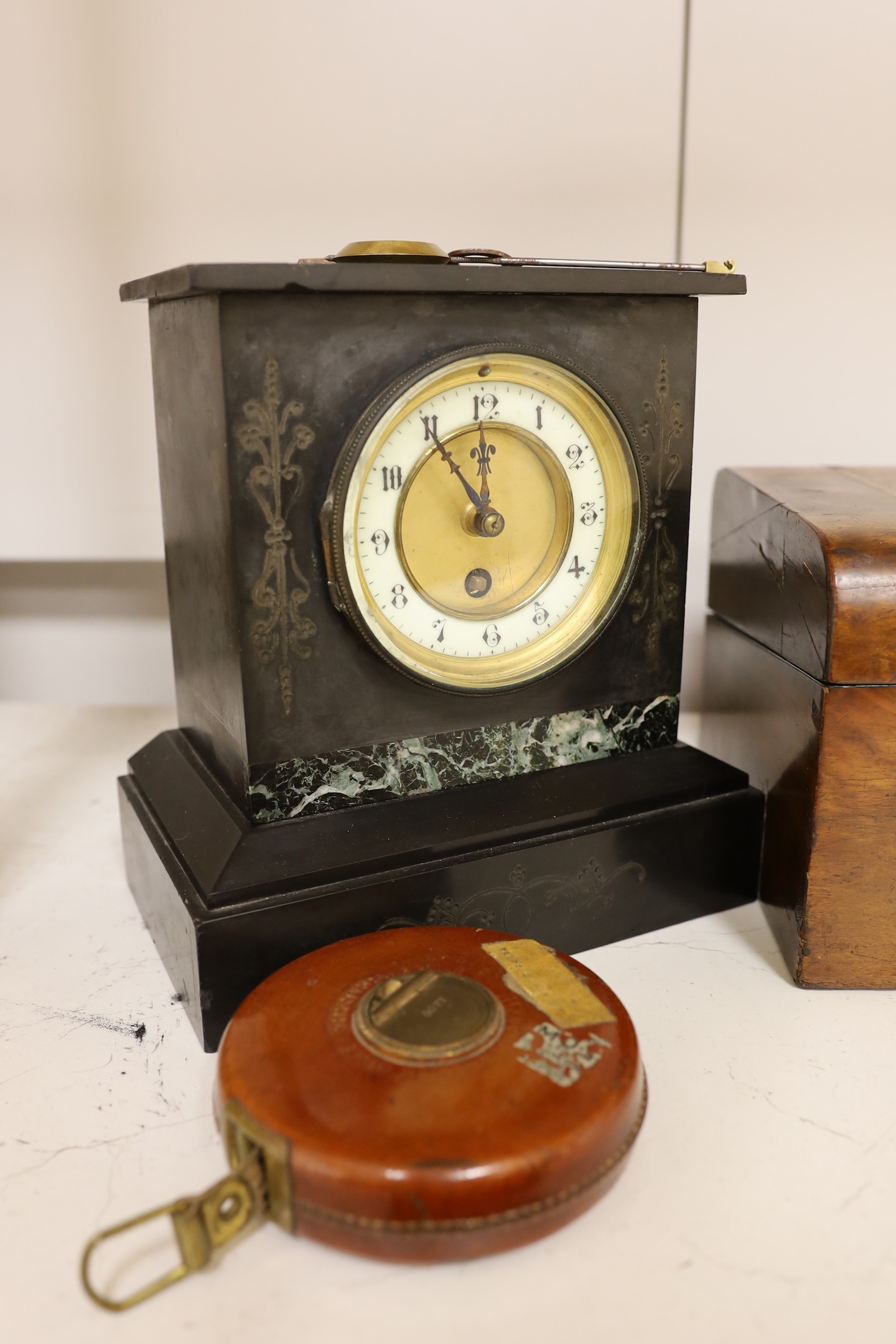 A Victorian black slate mantel clock, a parquetry writing box, a surveyor's measure, a cased French painter's set and various locks and keys